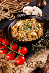 Mushrooms in cream sauce, julienne, champignon, products for cooking on the background of shale black Board