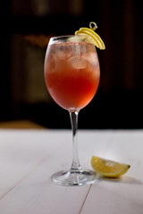 Cocktail with ice and lemon on black background. Alcohol drinks concept