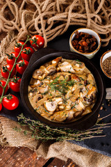 Mushrooms in cream sauce, julienne, champignon, products for cooking on the background of shale black Board