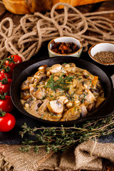 Mushrooms in cream sauce, julienne, champignon, products for cooking on the background of shale black Board