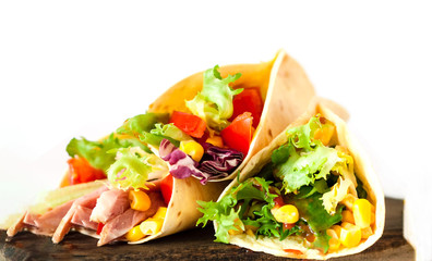 Traditional dish of Mexican cuisine. Corn tortilla tacos with vegetable filling on isolated white background. 