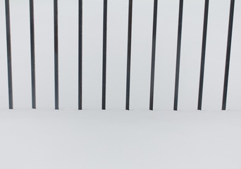 Metal black fence in the snow
