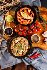Fried large shrimp in tomato sauce with olive oil,Mushrooms in cream sauce, julienne, champignon, products for cooking