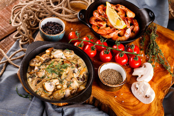 Fried large shrimp in tomato sauce with olive oil,Mushrooms in cream sauce, julienne, champignon, products for cooking