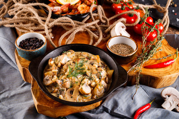 Fried large shrimp in tomato sauce with olive oil,Mushrooms in cream sauce, julienne, champignon, products for cooking