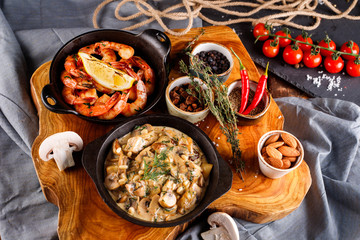 Fried large shrimp in tomato sauce with olive oil,Mushrooms in cream sauce, julienne, champignon, products for cooking