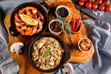 Fried large shrimp in tomato sauce with olive oil,Mushrooms in cream sauce, julienne, champignon, products for cooking