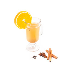 Glass with orange tea and a citrus segment.