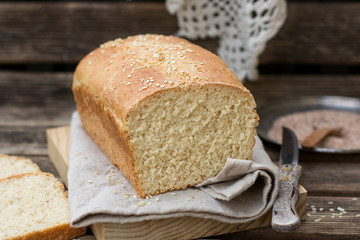 Loaf of white bran bread with sesame seeds