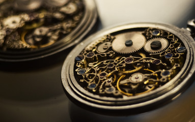 Skeleton of vintage handmade antique mechanical pocket watches, clockwork old mechanical watch, high resolution and detail, winter time and summer time concept. selective focus.