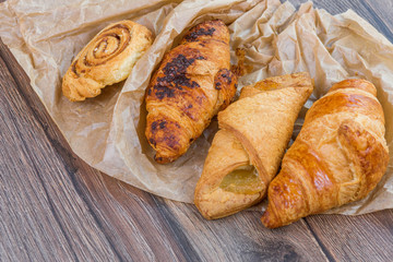 Sweet breakfast concept. Baked croissants on wooden table