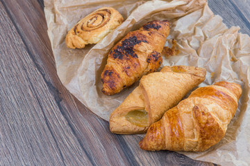 Sweet breakfast concept. Baked croissants on wooden table