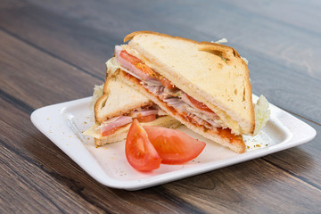 Sandwich with tomatoes and bacon on plate. Breakfast, food phto concept