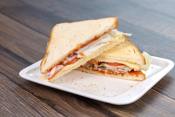 Sandwich with tomatoes and bacon on plate. Breakfast, food phto concept