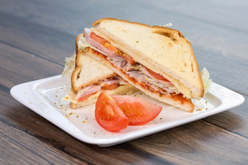 Sandwich with tomatoes and bacon on plate. Breakfast, food phto concept