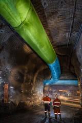 Miners inspecting an underground ventilation system in a gold mine in Australia
