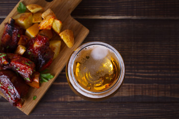 Beer and pork spare ribs with fry. Beer and meat. Glass of ale. overhaed, horizontal
