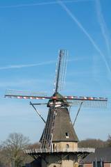Spring landscape with traditional Dutch windmill in Brabant