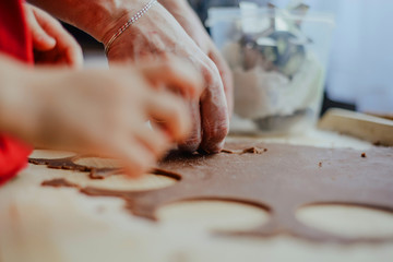 Help children during baking and cooking. The child helps to prepare the dough for baking. Baking cookies, family baking together. Flooding, making cookies. The concept of cooking.