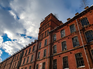 Fototapeta premium Old architectural plant. Old abandoned red brick factory.Ancient construction.