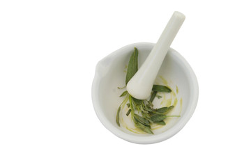 white mortar and pestle with herbs on white background