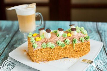 Delicious cake with coffee latte on wooden table