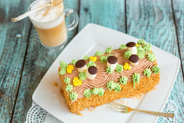 Delicious cake with coffee latte on wooden table