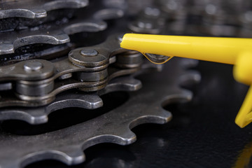 A gear and chain on a workshop table. Oiling and repair of bicycle drive.