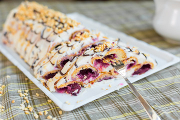 Bakery delicious food concept. Big tasty cake with nuts and cherry inside with cream 