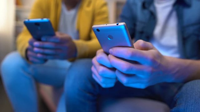 Nervous teenagers scrolling old models smartphones, slow internet connection
