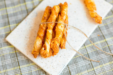 Cheese chips on plate. Baked tasty snack, food photo concept