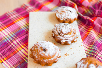 Delicious cakes on desk with sugar and raisins. Food photo for menu