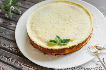 Cheese cake on white plate with mint. Sugar dessert, photo for menu