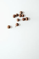 Allspice on a light, white background. Seeds of herbal medicine located on a white background. The concept of spices and adding spices to eat.