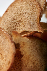 Sliced brown bread close up. Unusual edible texture for a culinary site, advertising. Traditional Russian, Ukrainian, Belarusian, Slavic dark bread. Preparation for sandwiches.