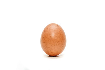 Egg isolated on white. Using an egg for preparing an omelette, scrambled eggs. Chicken egg lies on a white table.