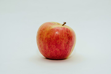 Fresh red apple isolated on white. Delicious apples lie on the table. The concept of providing vitamins along with fruits. Eating fruit on a daily basis.