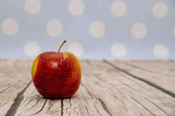 Fresh red apple on wooden. Delicious apples lie on the table. The concept of providing vitamins along with fruits. Eating fruit on a daily basis.