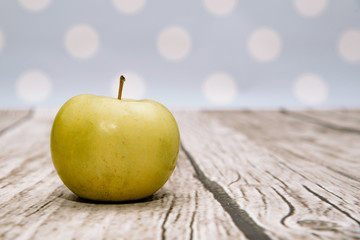 Fresh green apple on wooden. Delicious apples lie on the table. The concept of providing vitamins along with fruits. Eating fruit on a daily basis.