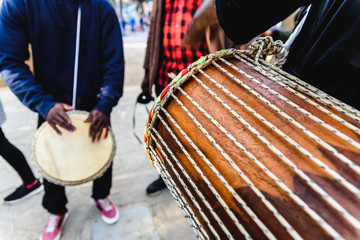 Fototapeta na wymiar African drummers blowing their bongos on the street.