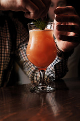Close up of bartender serving a cocktail