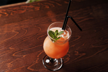 Alcoholic cocktail on the basis of gin, cherry, orange and liqueur Benediktin, grenadine, pineapple...