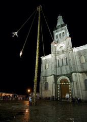  A family of acrobats known as "los voladores" perform in the Cuetzalan zocalo, in front of Parroquia de San Francisco de Asís, Cuetzalan, Mexico.