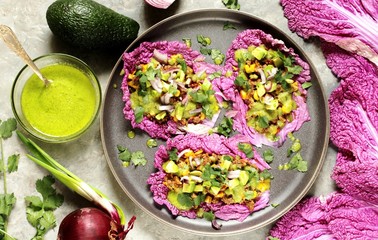 keto diet taco food is wrapped instead of cakes in cabbage leaf of Peking cabbage with avocado mayo with avocado, ground beef, onions, corn and cilantro, healthy fats without carbohydrates.
