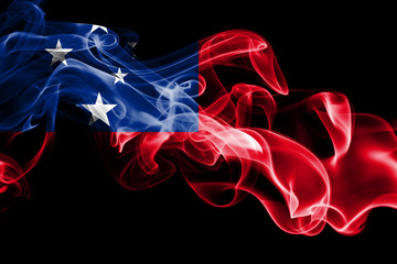 National flag of Samoa made from colored smoke isolated on black background. Abstract silky wave background.