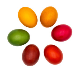 Six colorful Easter eggs flat lay in a circle and isolated on plain white background