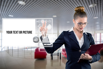 Young business lady works with virtual graphic interface in futuristic office