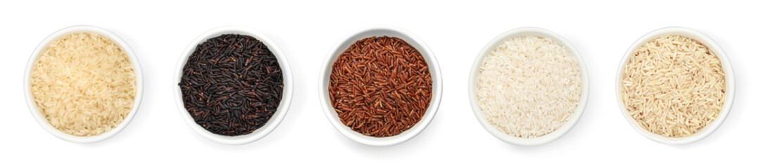 Set of bowls with different uncooked rices on white background, flat lay