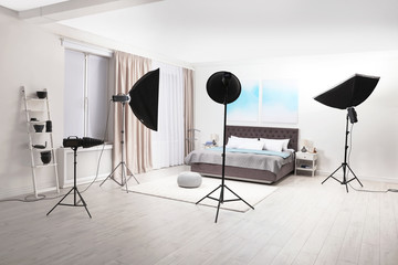 Professional photo studio equipment prepared for shooting bedroom interior