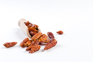 piri piri peppers in wooden scoop isolated on white background. Closeup.